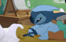 stitch is wearing a sleep cap and sleeping on a bed