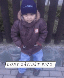 a little boy wearing a blue hat that says " lock "