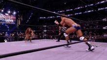 a wrestling match is underway with a sign that says double nothing