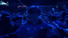 a man in a kappa shirt is surrounded by a crowd of people