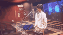 a man singing into a microphone in a recording studio