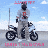 a man standing on a motorcycle with the words quite time is over on the bottom