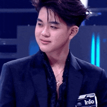 a young man in a black suit has a name tag that says info