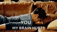 a man is laying on a couch with his head on a pillow and the words `` you my brain hurts '' .