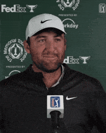 a man wearing a fedex hat and a nike jacket