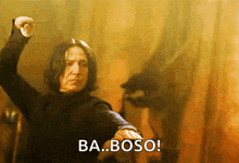a man in a black shirt is holding his fist up and says ba.boso
