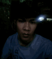 a young man wearing a blue shirt that says 30 on it