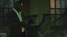 a man is holding a gun with a fire coming out of it in front of a prime logo