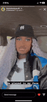 a person wearing a hat that says ny is sitting in a car