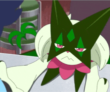 a green and white cartoon character with a pink bow on its head