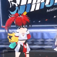 a girl with red hair is standing on a stage in front of a sign that says holo .