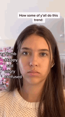 a young woman is making a funny face with the words numb happy sad angry confused on her face .