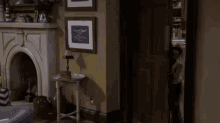 a young boy is standing in a living room next to a fireplace and a chair .