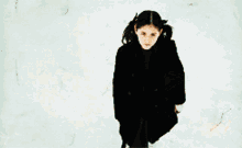 a person is standing in a dark room with a fire coming out of a window