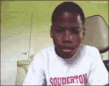 a boy wearing a shirt that says souderton