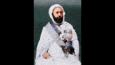 a man with a beard is wearing a white robe with a sash around his neck that says ' egypt ' on it