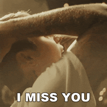 a man holding a baby with the words " i miss you " above him