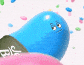a blue jelly bean with a sad face is sitting on a pink jelly bean