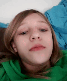a young girl with a green scarf around her neck