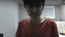 a man wearing glasses and a red shirt that says marvel spider-man