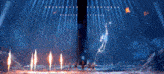 a group of people standing on a stage with flames coming out of it