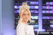 a blonde woman wearing a crown and a sash that says ' miss ' on it