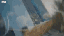 a yellow van is driving down a city street with a roof rack on top of it .