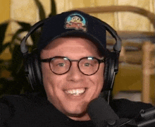 a man wearing headphones and a hat with a monkey on it