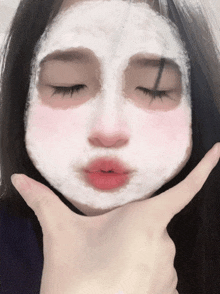 a girl with a white mask on her face is making a funny face