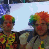 two men dressed up as clowns with one wearing a t-shirt that says ' i 'm a clown '