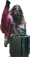a man with a beard is holding a large metal object with chains around it