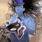 a man in a purple top hat is holding a purple and black object