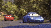 a couple of cars are driving down a road .