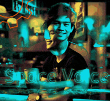 a man sits at a table in front of a sign that reads space voice