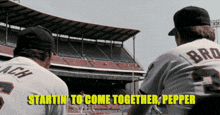 two baseball players are standing in front of a stadium with the words startin to come together pepper above them