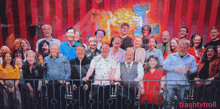 a large group of people are posing for a picture and the words trashtvtroll are on the bottom right