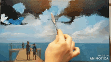 a person is painting a picture of people on a pier with the words made in animotica on the bottom