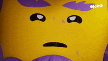 a yellow cartoon face with a purple background and the word ok on the bottom