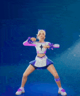 a cheerleader in a pink and white outfit is standing with her arms in the air
