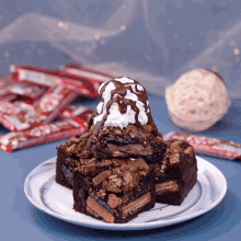 a stack of brownies with ice cream on top on a plate