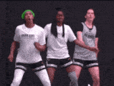 three women wearing shirts that say brown state are dancing