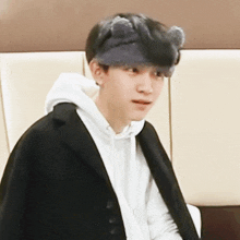 a man wearing a headband with cat ears on it
