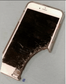 a phone with a broken screen and a case on it