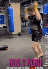 a man is jumping in the air in a gym with the words kdo s koho on the bottom