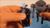a person is holding two toy figures in their hands
