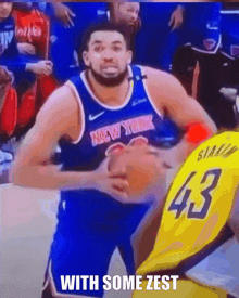 a man in a new york jersey is holding a basketball in his hands