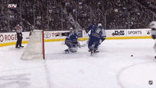 a hockey game is being played in front of a banner that says play now sports