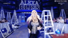 alexa bliss is walking down the aisle of a wrestling ring