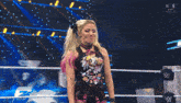 a woman in a wrestling ring is wearing a shirt that says ' n live ' on it