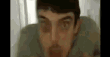a blurry picture of a man 's face with a beard .